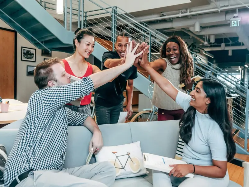 A team celebrating together with a high five