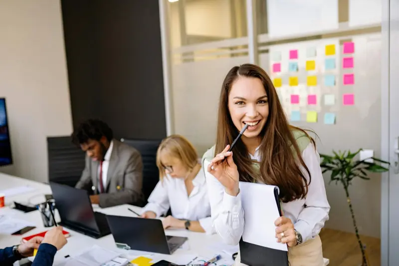 A smiling professional in an office meeting
